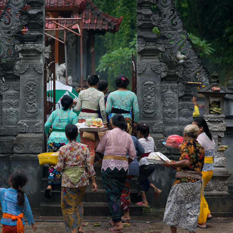 group of people entering the temple to make offerings