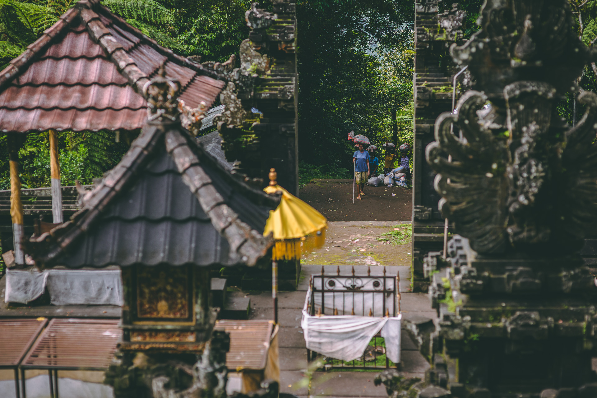women carrying food and hiking to the temple